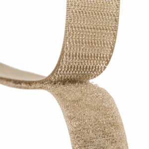 Close-up of a beige hook-and-loop fastening strap on a plain white background.