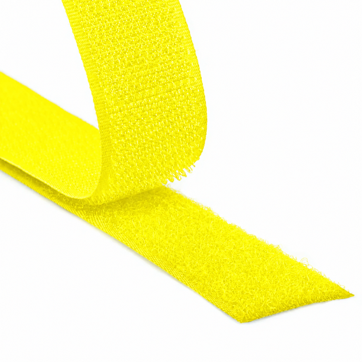 Close-up of a fluorescent yellow hook and loop fastener tape showing both hook and loop sides on a white background