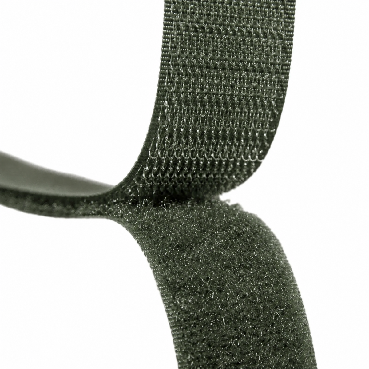 Close-up of a dark olive green hook-and-loop fastening strap against a plain white background.