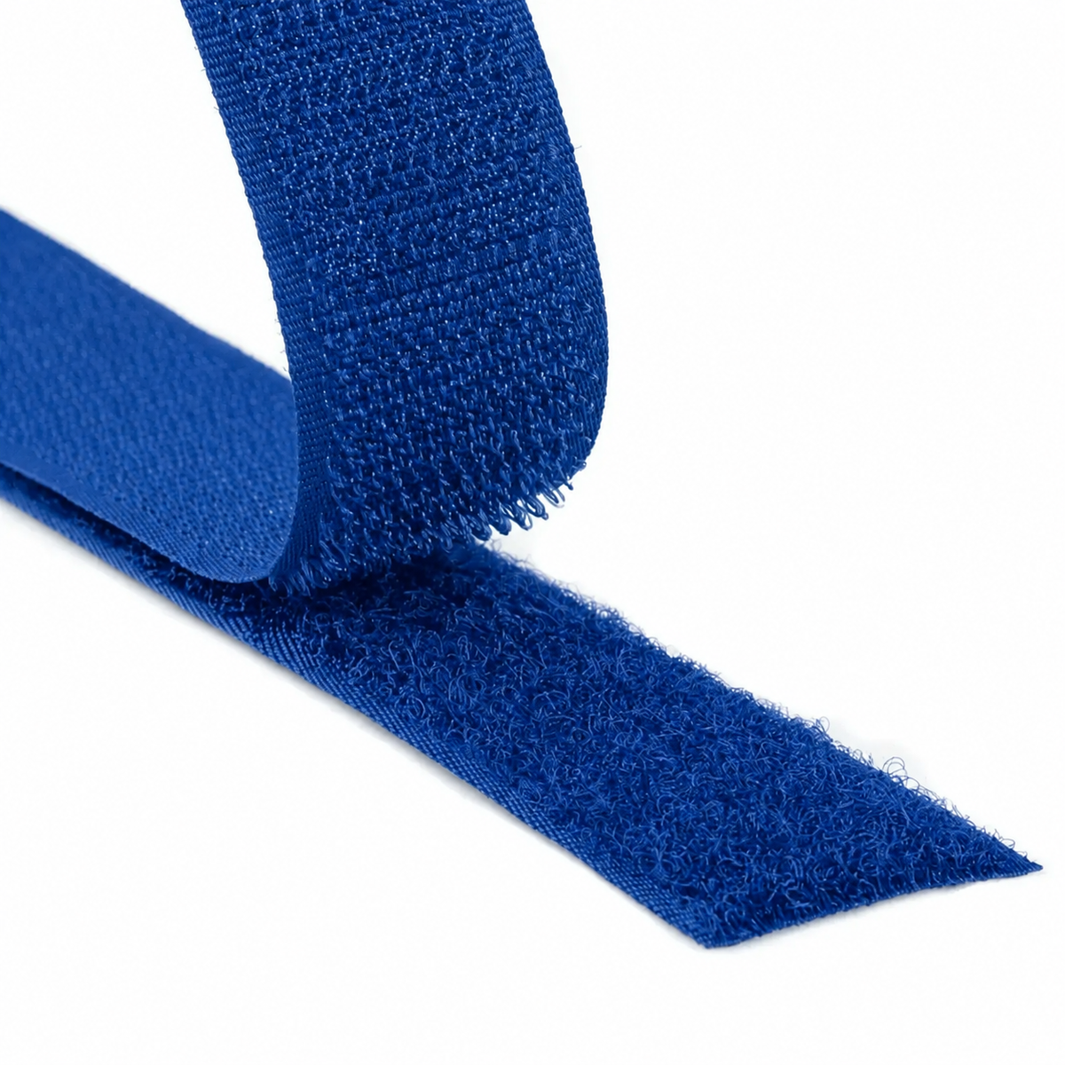 Close-up of a blue hook and loop fastener tape showing both hook and loop sides on a white background