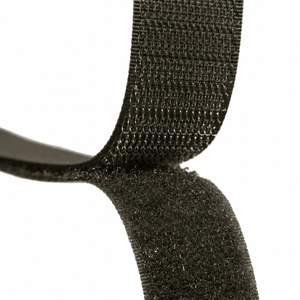 Close-up of an olive green hook-and-loop fastening strap against a plain white background.